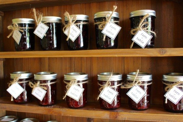 Rows of jam jars on shelves at Farm + Table