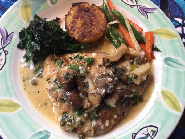 Mahimahi with sautéed mushrooms and capers.