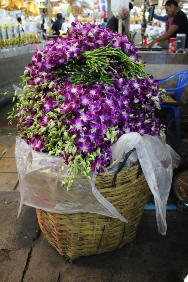 Piles and piles of orchids at the flower market are just one of the ten reasons to visit Thailand.