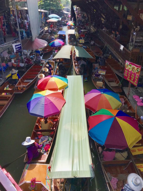An-overhead-view-of-the-colorful-floating-market-in-Thailand. Ten reasons to visit Thailand and best reason is to visit the colorful floating market.