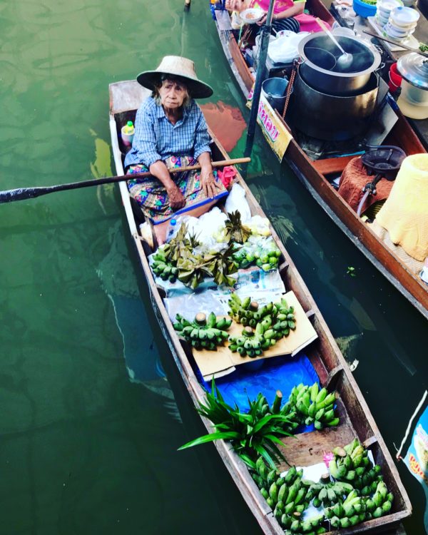 Old-Thai-lady-in-boat-selling-fruit-at-floating-market-in-Thailand. Ten reasons to visit Thailand and the floating markets were my favorite.