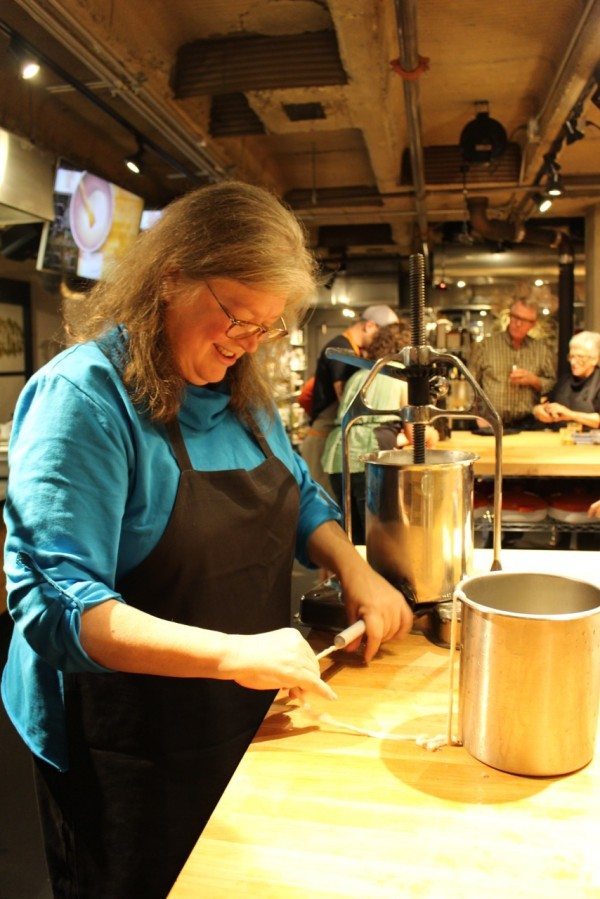 A fellow student loading the casing on the spout.